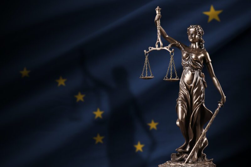 Alaska US state flag with statue of lady justice